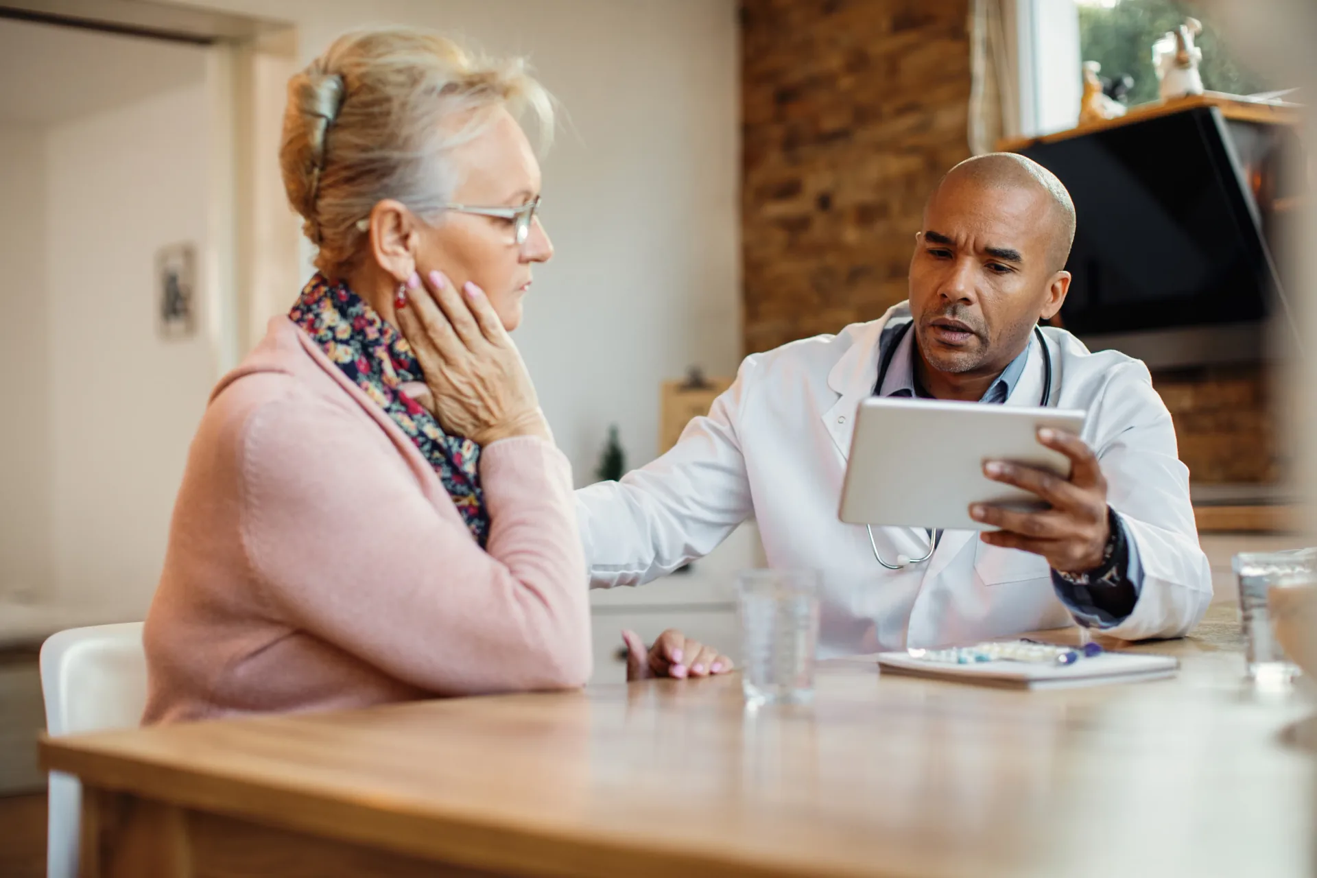 Healthcare professional speaking with an older person