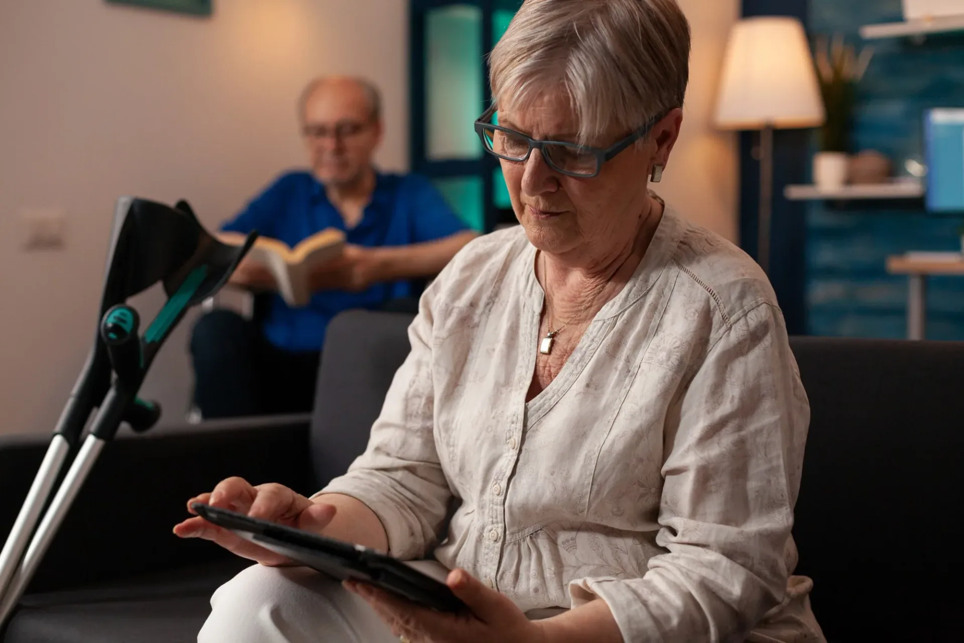 Person using a tablet while receiving support at home