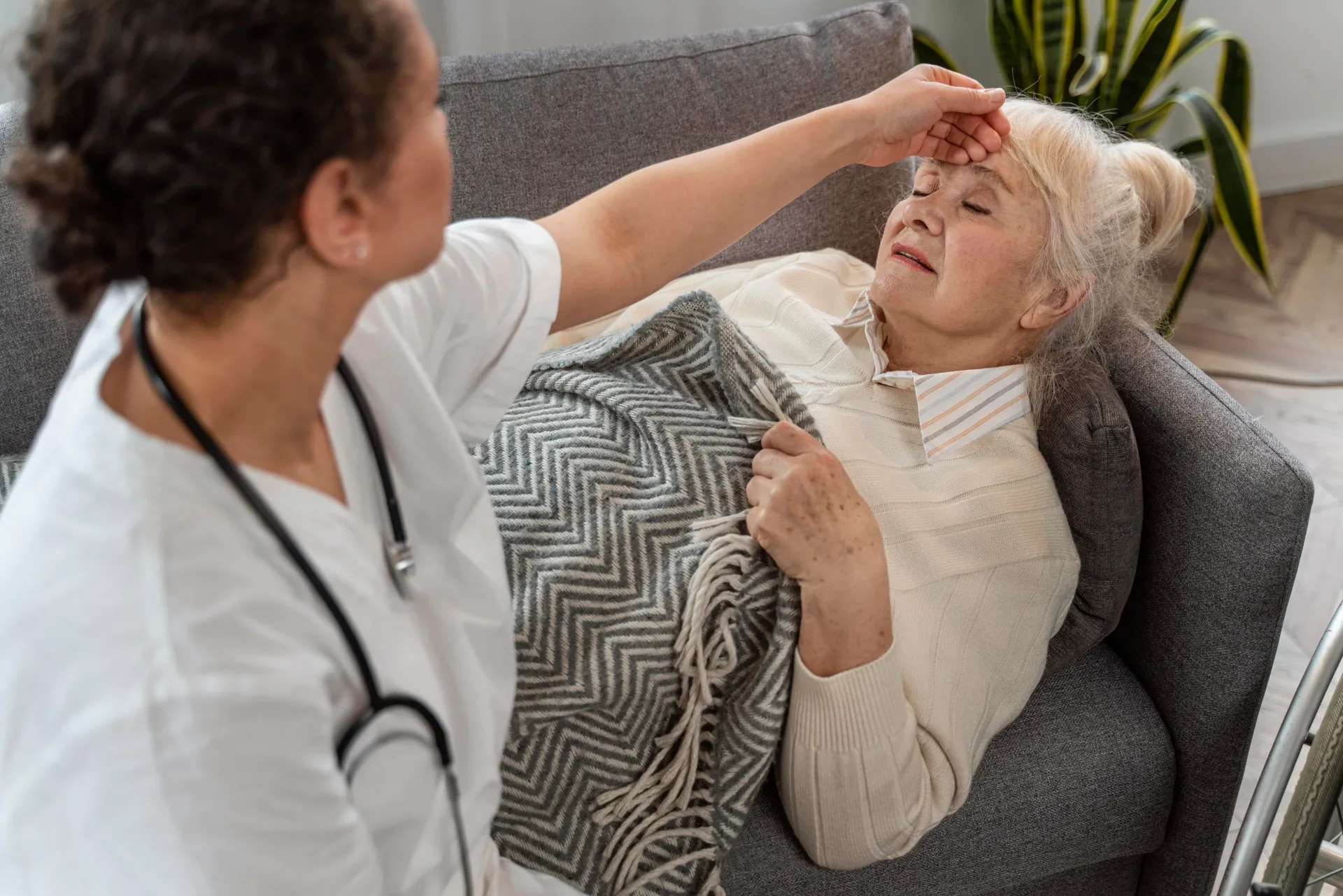Care worker supporting an older person with muscular dystrophy