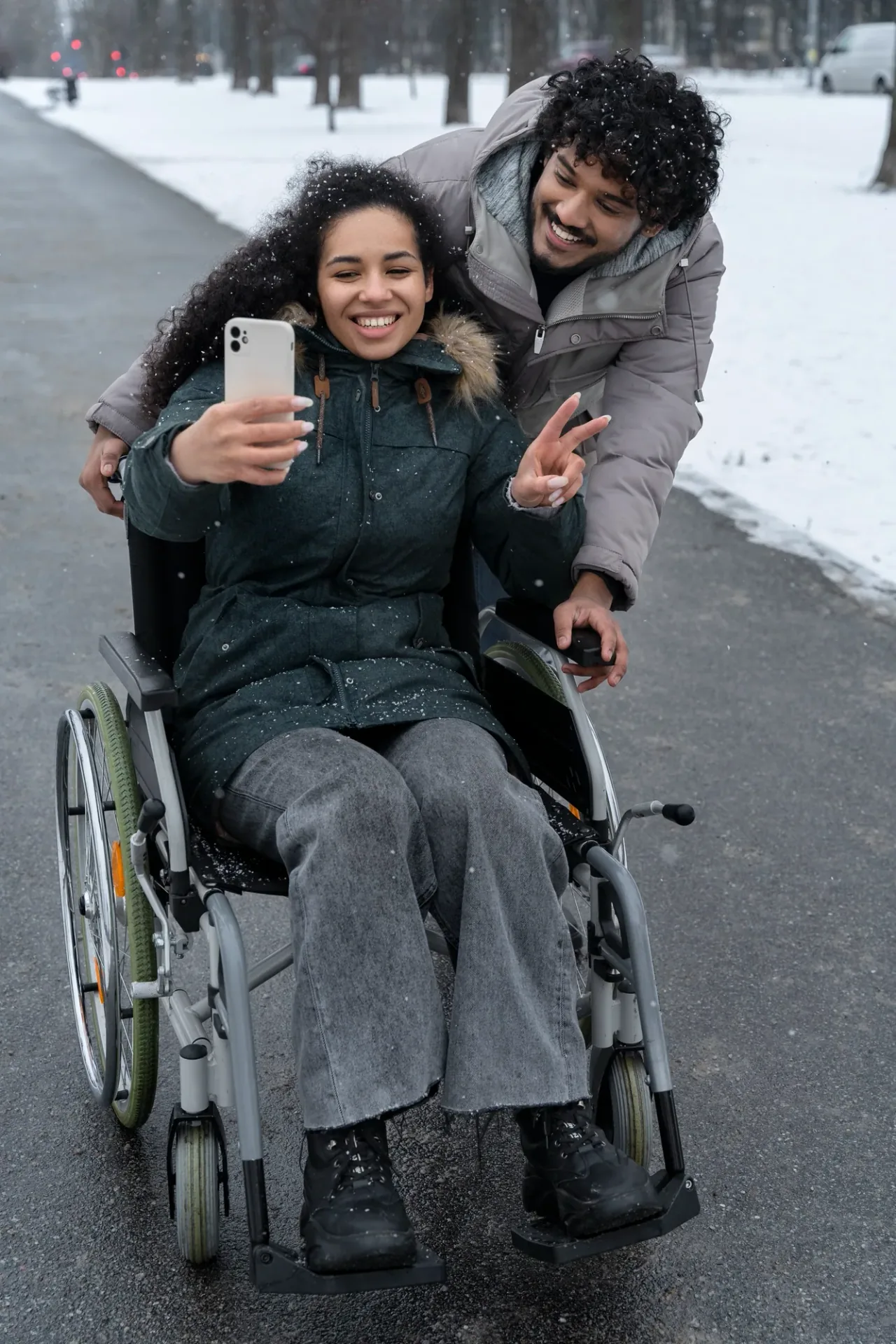 Person in a wheelchair outdoors with companion