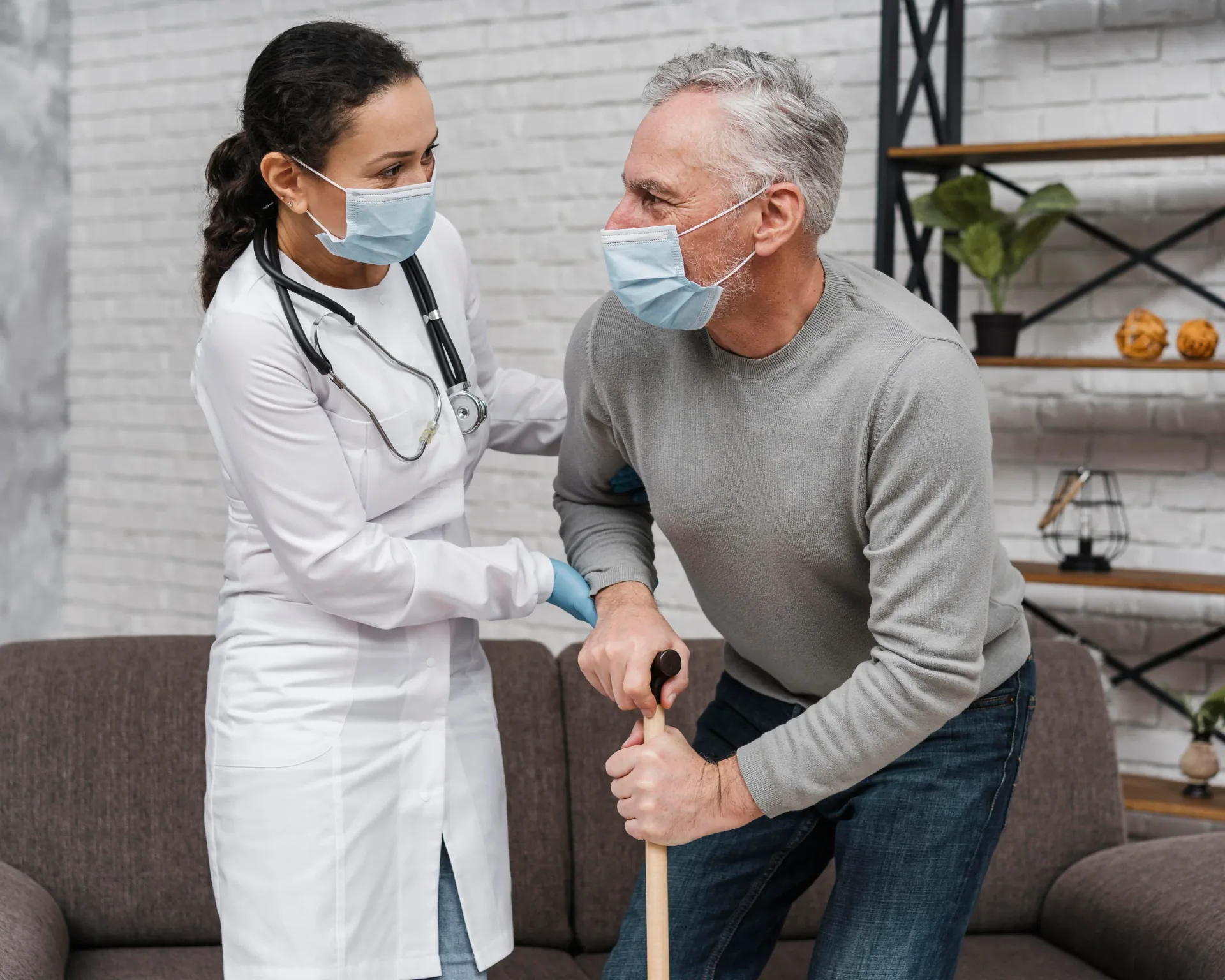 Healthcare worker supporting an older adult with walking