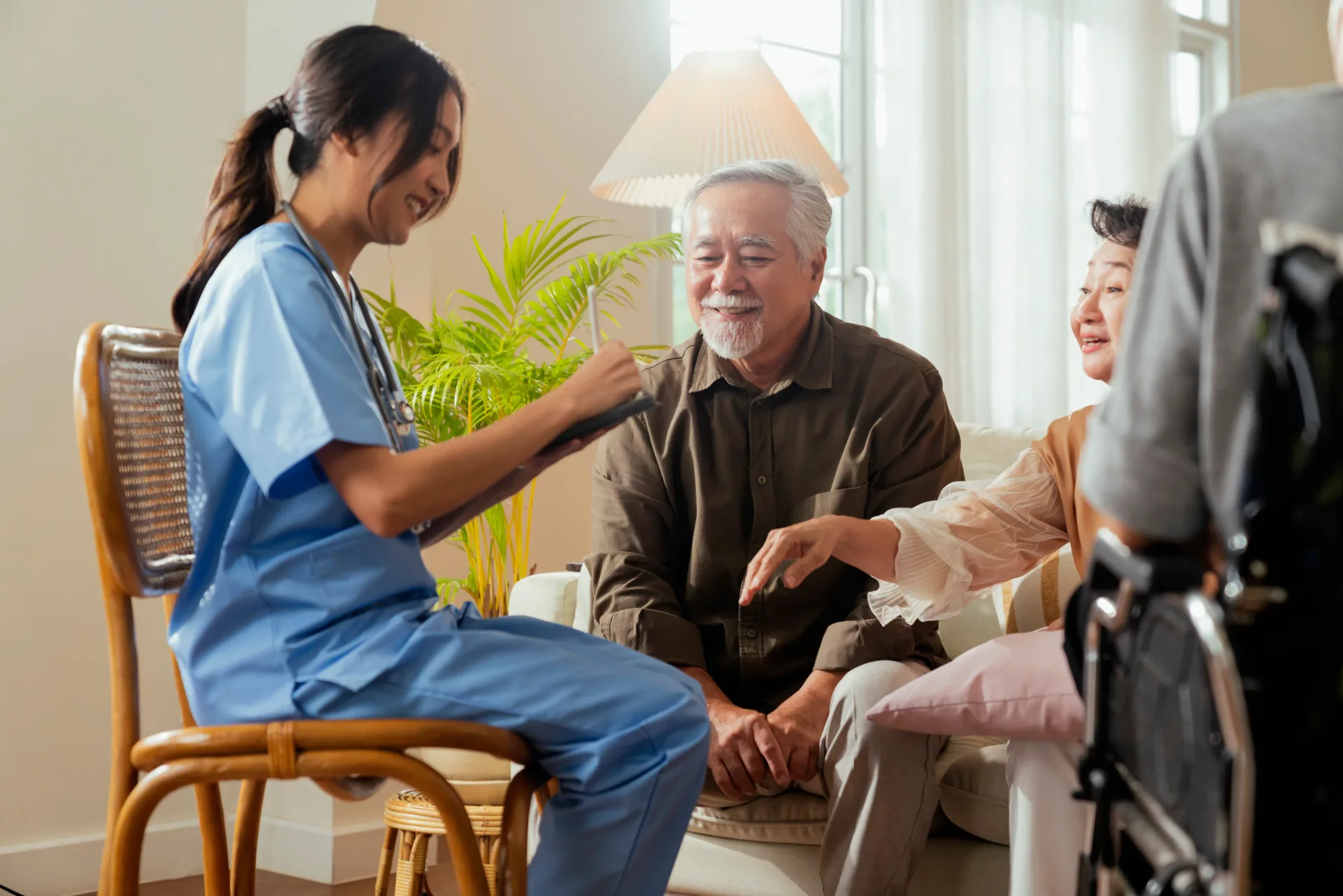 Care worker supporting an older adult and family member